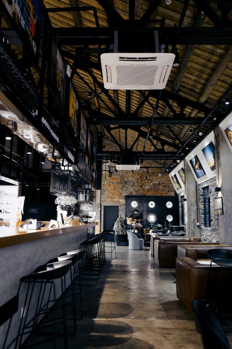 Notre cave Modern bar interior showcasing cozy seating and artistic decor in a stylish setting.