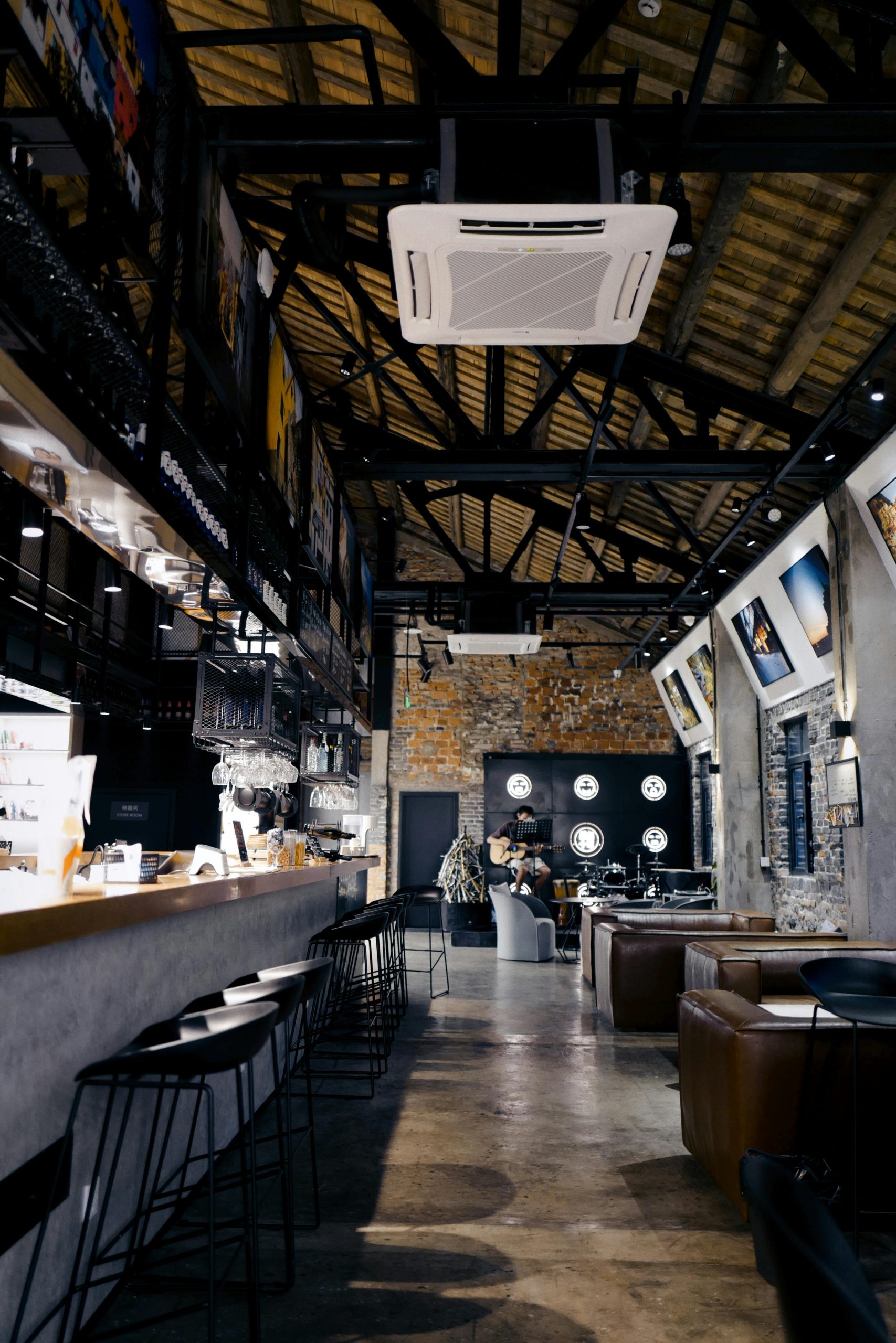 Accueil Modern bar interior showcasing cozy seating and artistic decor in a stylish setting.